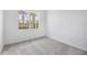 Well-lit bedroom with a view and neutral carpeting at 5901 Mariposa Ln, Sarasota, FL 34238