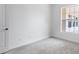 Spacious bedroom with large window and neutral walls at 5901 Mariposa Ln, Sarasota, FL 34238