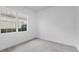 Charming bedroom with a window overlooking the backyard at 5901 Mariposa Ln, Sarasota, FL 34238