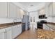 Modern kitchen with stainless steel appliances and granite counters at 5901 Mariposa Ln, Sarasota, FL 34238