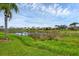 Scenic lake view with lush landscaping and neighborhood homes at 5901 Mariposa Ln, Sarasota, FL 34238