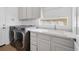 Laundry room with cabinets, sink, and washer/dryer hookups at 5901 Mariposa Ln, Sarasota, FL 34238