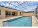 Inviting pool and patio area with covered lanai and solar panels at 5901 Mariposa Ln, Sarasota, FL 34238