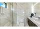 Modern bathroom with glass shower, marble tile, and floating vanity at 1610 N Lodge Dr, Sarasota, FL 34239