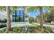 Modern home entryway with glass doors and tropical landscaping at 1610 N Lodge Dr, Sarasota, FL 34239