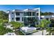 Modern white two-story home with a sleek design and palm trees at 1610 N Lodge Dr, Sarasota, FL 34239