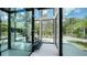 Modern glass staircase with views of the tropical backyard at 1610 N Lodge Dr, Sarasota, FL 34239