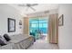 Bedroom features neutral decor, water views and access to balcony at 5444 Gulf Of Mexico Dr, Longboat Key, FL 34228