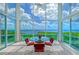 Sun-drenched dining area with floor-to-ceiling windows showcasing beautiful bay views at 5444 Gulf Of Mexico Dr, Longboat Key, FL 34228