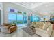 Bright living room boasts water views, tile floors, high ceilings, and comfortable seating at 5444 Gulf Of Mexico Dr, Longboat Key, FL 34228