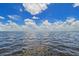 Expansive water view showing rippling clear water with bright blue sky and scattered clouds at 5444 Gulf Of Mexico Dr, Longboat Key, FL 34228