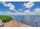 Wooden dock extending into the water offering stunning sky and water views at 5444 Gulf Of Mexico Dr, Longboat Key, FL 34228