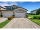 Tan two-story home with two-car garage and paver driveway at 5830 Wake Forest Run # 104, Bradenton, FL 34211