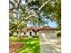 Single-story home with a two-car garage and mature landscaping at 623 147Th E St, Bradenton, FL 34212