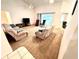Living room with vaulted ceiling, neutral carpet, and two recliners at 623 147Th E St, Bradenton, FL 34212
