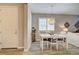 Bright dining room with white table and chairs, and wood floors at 8930 Tuscany Isles Dr, Punta Gorda, FL 33950