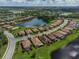 An aerial view of a home nestled in a community with a lake and golf course at 7112 Marsh View Ter, Bradenton, FL 34212