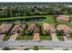 An aerial view showcases a row of homes with tile roofs and lush landscaping at 7112 Marsh View Ter, Bradenton, FL 34212