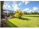 Landscaped backyard with pond view and screened patio at 7112 Marsh View Ter, Bradenton, FL 34212