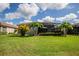Spacious backyard with lush lawn and tropical plants at 7112 Marsh View Ter, Bradenton, FL 34212
