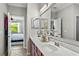Double vanity bathroom with a view of a bedroom at 7112 Marsh View Ter, Bradenton, FL 34212