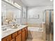 Double vanity bathroom with soaking tub and walk-in shower at 7112 Marsh View Ter, Bradenton, FL 34212