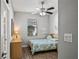 Bedroom with wood floors, ceiling fan, and window at 7112 Marsh View Ter, Bradenton, FL 34212