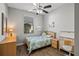 Bedroom with wood floors, ceiling fan, and built-in desk at 7112 Marsh View Ter, Bradenton, FL 34212
