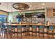 Clubhouse bar with a curved counter and teal barstools at 7112 Marsh View Ter, Bradenton, FL 34212