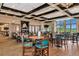 Clubhouse dining area with wood floors and teal chairs at 7112 Marsh View Ter, Bradenton, FL 34212