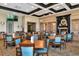 Clubhouse dining area with wood floors and teal chairs at 7112 Marsh View Ter, Bradenton, FL 34212