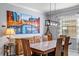 Bright dining room featuring a wood table and statement art at 7112 Marsh View Ter, Bradenton, FL 34212