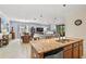 Open floor plan with kitchen island, Gathering room, and dining area at 7112 Marsh View Ter, Bradenton, FL 34212