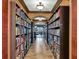 Long library hallway with floor to ceiling bookshelves at 7112 Marsh View Ter, Bradenton, FL 34212