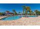 Community pool with lounge chairs and umbrellas at 7112 Marsh View Ter, Bradenton, FL 34212