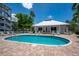 Resort-style pool with surrounding lounge chairs and clubhouse view at 1260 Dolphin Bay Way # 203, Sarasota, FL 34242