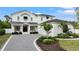 Stunning two-story home featuring a manicured lawn, beautiful landscaping, and a stylish black and white color scheme at 1783 Bayview Dr, Sarasota, FL 34239