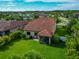 A well-maintained home with a screened lanai, verdant lawn, and tropical landscaping at 2352 Marton Oak Blvd, North Port, FL 34289