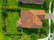 Home with a terracotta roof and a lush green lawn, complemented by mature landscaping at 2352 Marton Oak Blvd, North Port, FL 34289