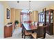 Elegant dining room featuring a large wooden table, plush chairs, and a decorative cabinet, perfect for entertaining guests at 5706 29Th E Ct, Bradenton, FL 34203