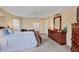 Spacious bedroom featuring a king bed, dresser, and ensuite bathroom at 5706 29Th E Ct, Bradenton, FL 34203