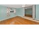 Light blue bedroom with hardwood floors and access to another room at 329 Bay Vista Ave, Osprey, FL 34229