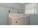 Bright laundry room with washer, dryer, and shelving at 329 Bay Vista Ave, Osprey, FL 34229