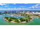 Panoramic aerial view of a marina with yachts, Sarasota cityscape, and clear blue skies at 105 New Briton Ct, Bradenton, FL 34212