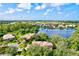 Beautiful aerial shot of a home with a lake view and manicured landscaping in a lush community at 105 New Briton Ct, Bradenton, FL 34212