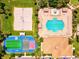 Aerial view of community amenities including a pool, sports field, beach volleyball, and parking at 105 New Briton Ct, Bradenton, FL 34212