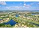 Expansive aerial view showcasing the community's golf course, lakes, and meticulously planned residential areas at 105 New Briton Ct, Bradenton, FL 34212