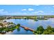 Stunning aerial view of a waterfront community with homes, a lake, and a scenic wooden pier at 105 New Briton Ct, Bradenton, FL 34212