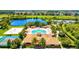 Aerial view of a luxurious community clubhouse, pool, and recreational facilities surrounded by lush landscaping at 105 New Briton Ct, Bradenton, FL 34212