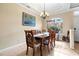 Cozy dining room with classic furniture, a chandelier, and a bright window offering natural light at 105 New Briton Ct, Bradenton, FL 34212